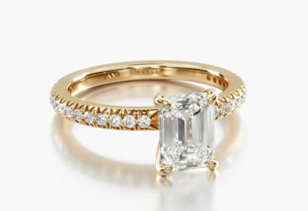 yellow gold French pave ring with emerald cut diamond