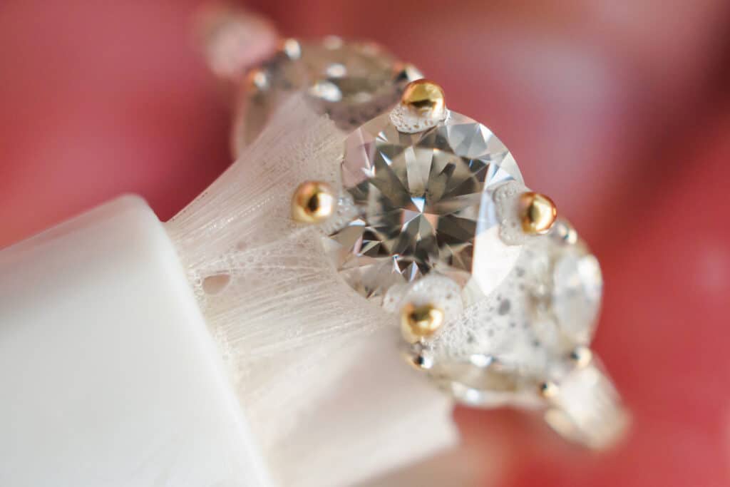 Cleaning a ring with soapy water and bristle brush